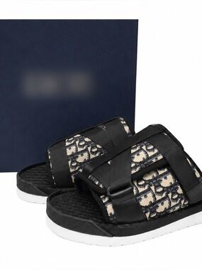 Black D..I..O..R slides with textured woven pattern